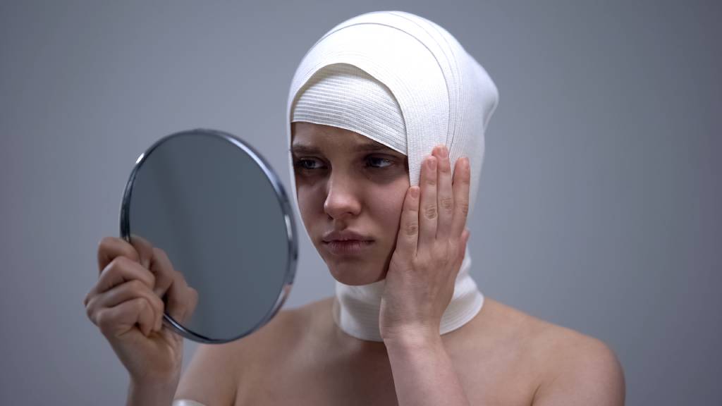 A woman in headwrap bandages after surgery