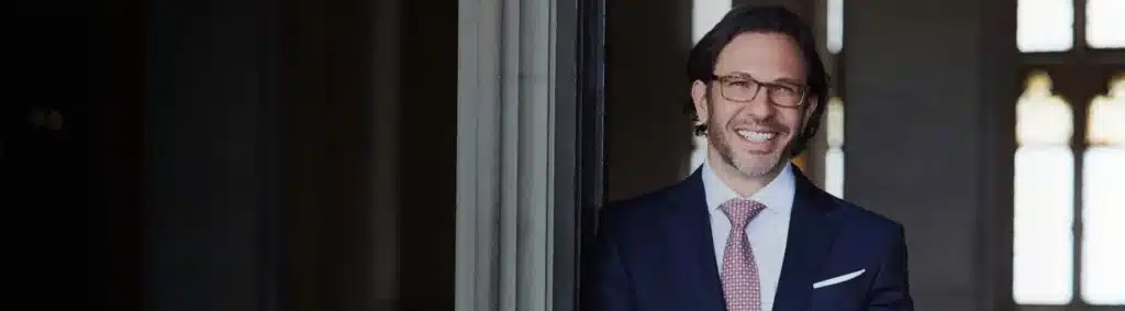 Dr. Andrew Jacono is Pictured in a Suit and Tie