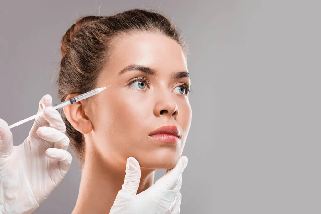 A woman getting a botox injection for her crow's feet 