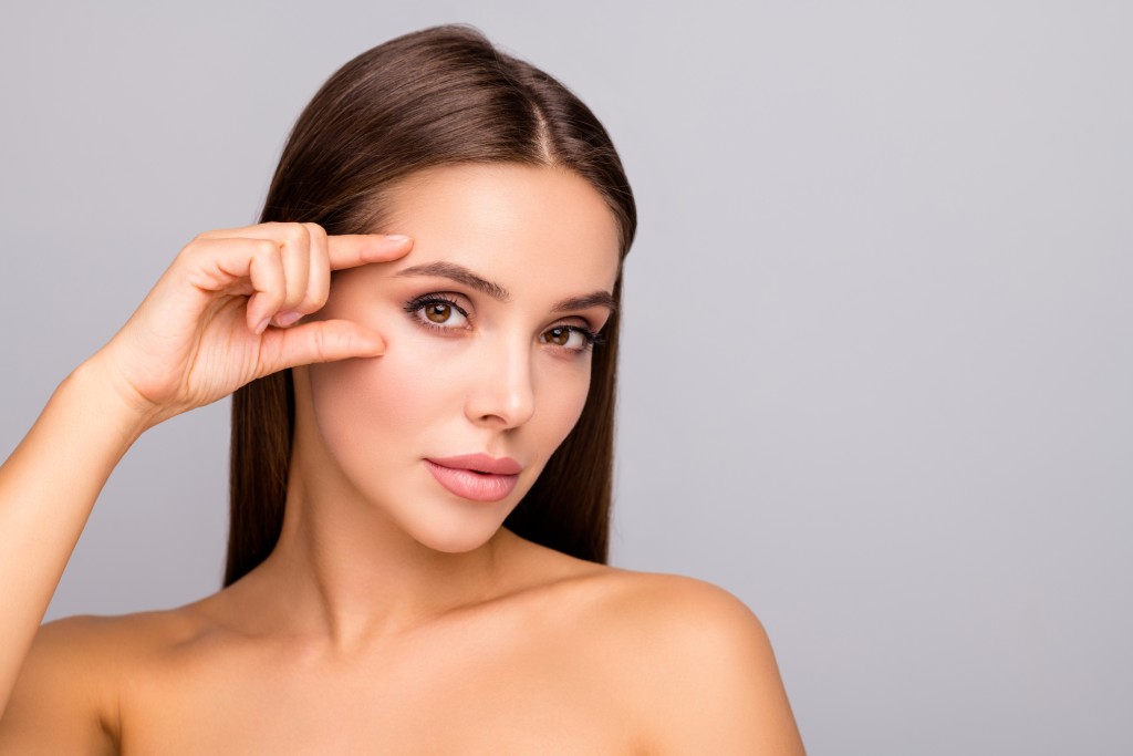 A beautiful woman touching her face