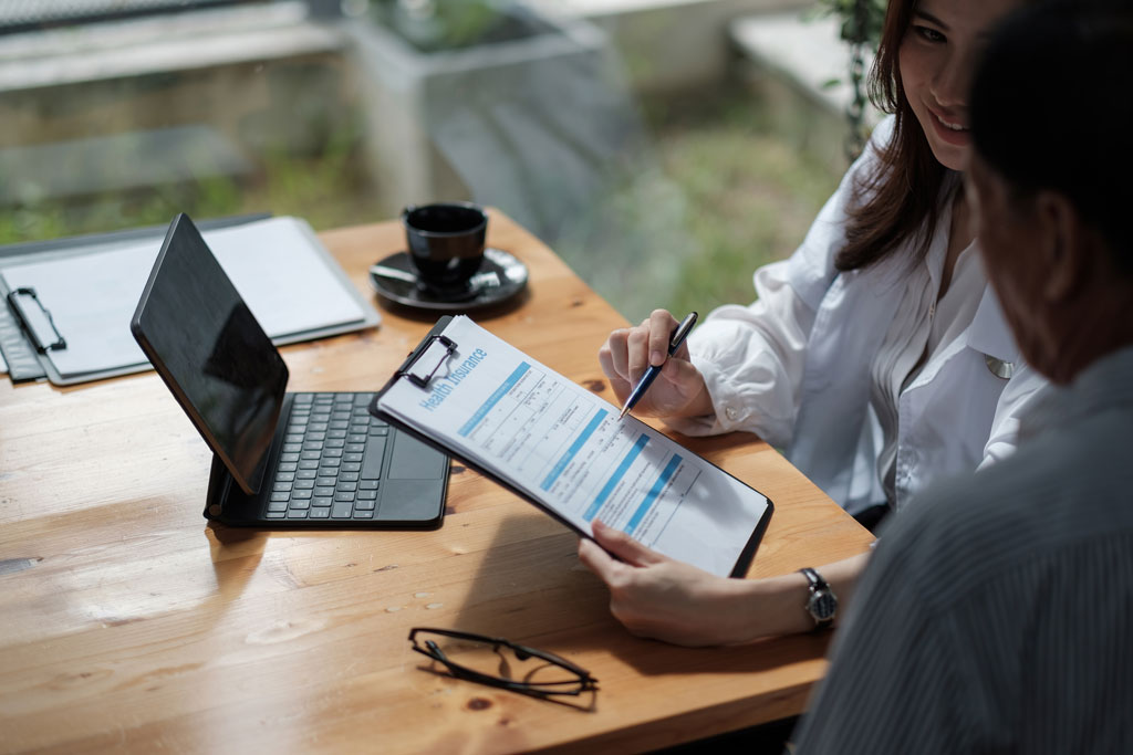 A doctor going over financing forms with a patient