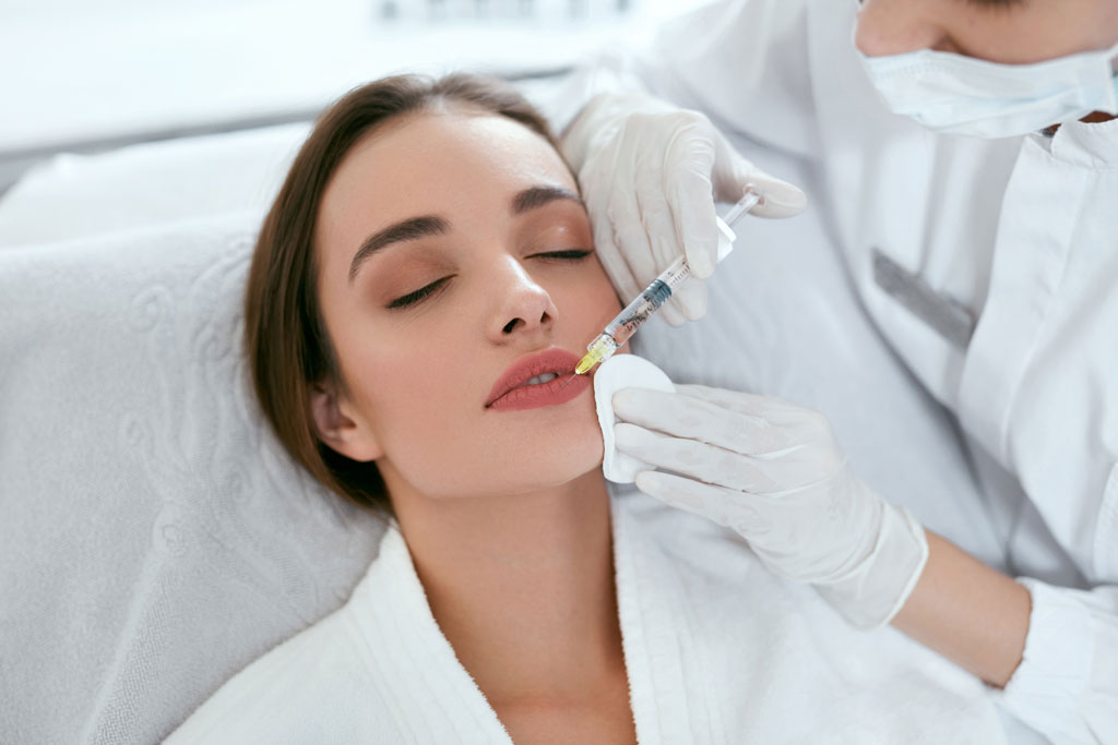 A woman getting injections in her lips