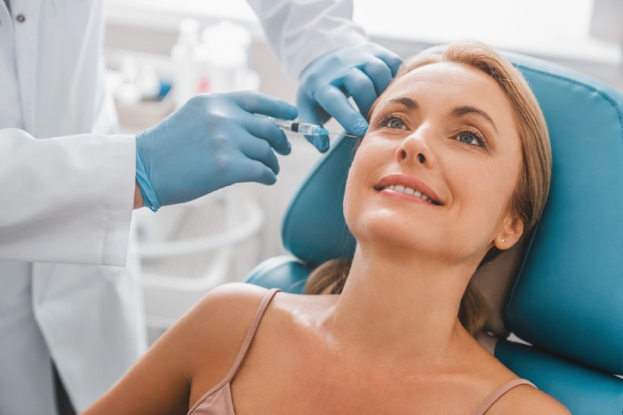 A woman getting a botox injection at her crow’s feet