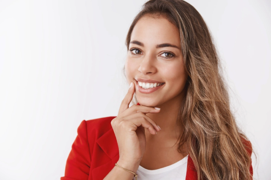 A woman touching her jawline