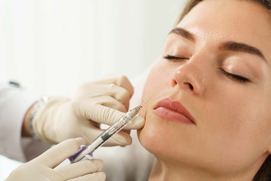 A woman getting fillers around her lips